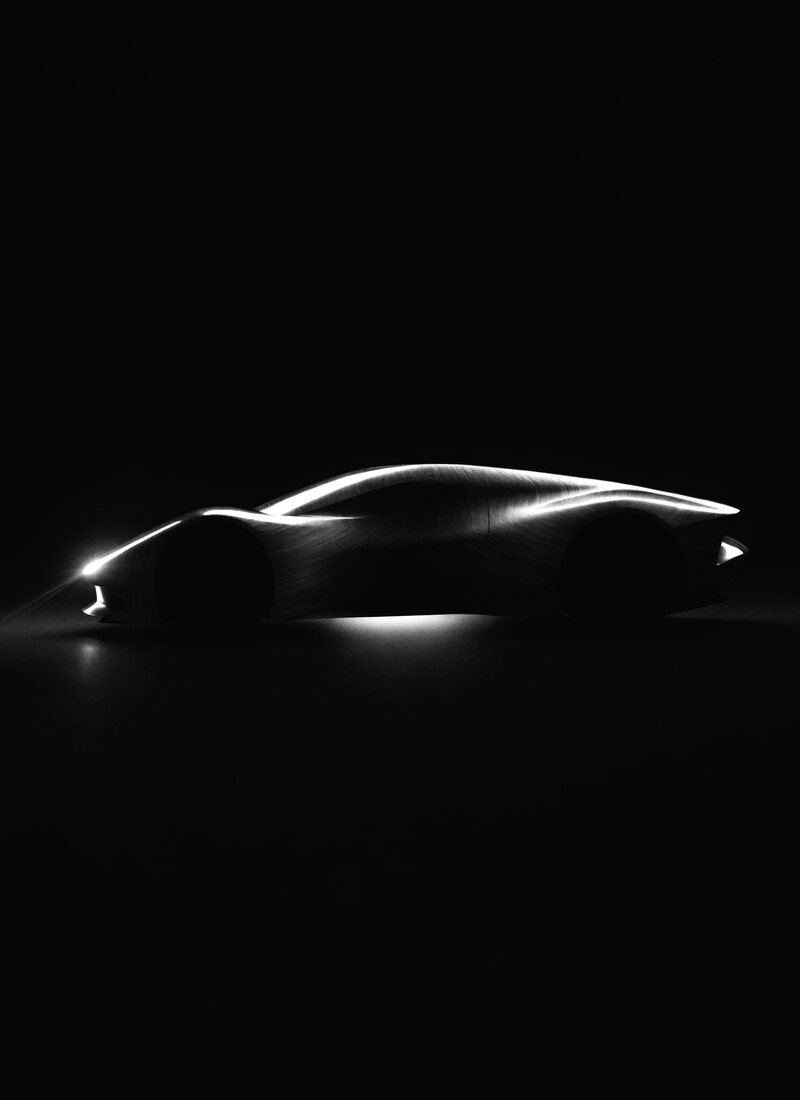 A low hypercar lit against a dark backdrop