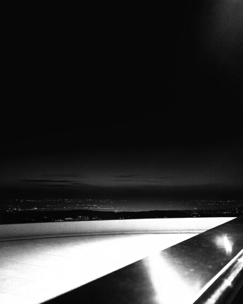 A high-floor terrace view over a coastal city